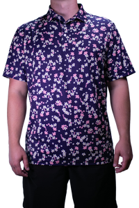 Person wearing a short-sleeve shirt with a floral pattern on a white background