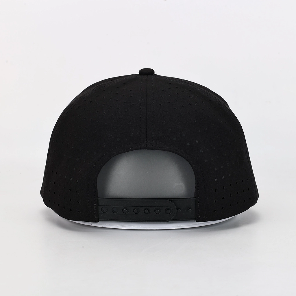 Black flat-brim cap shown from the back, featuring a perforated fabric crown and a black snapback closure on a white brim, photographed against a clean white background.