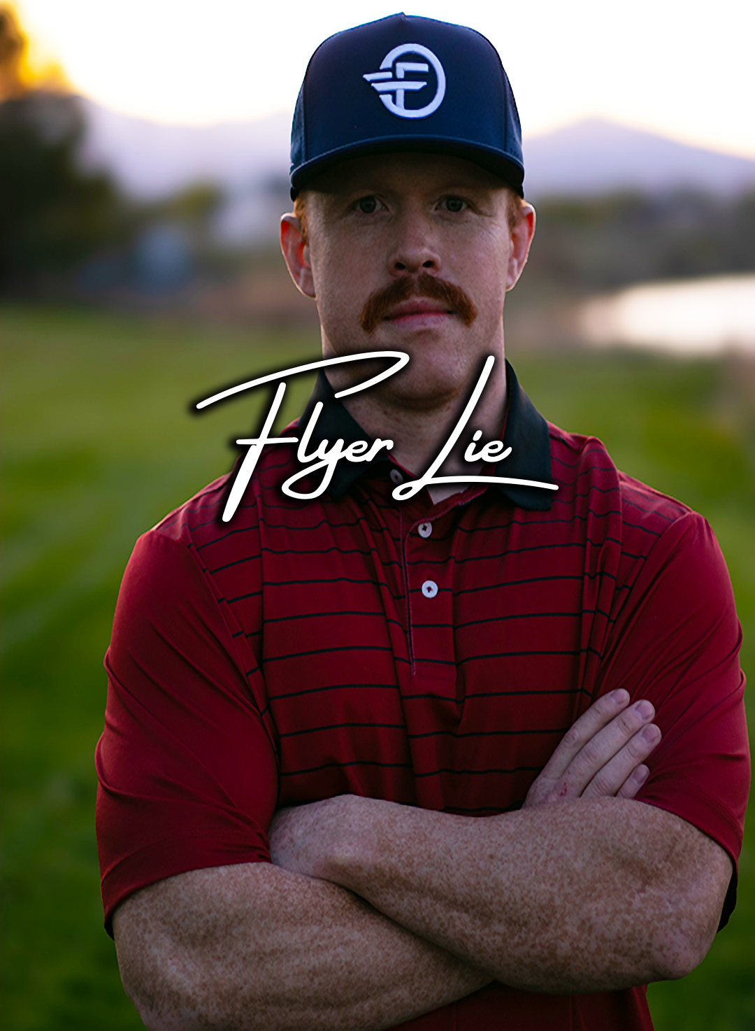 Man wearing a red shirt and blue cap with 'Flyer Lie' logo on a blurred outdoor background