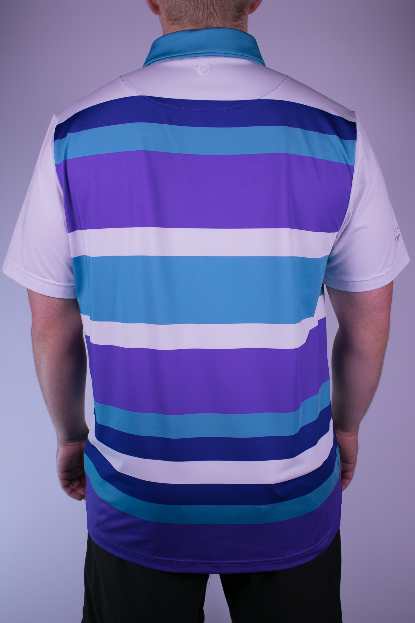 Person wearing a striped polo shirt with blue, purple, and white colors on a plain background