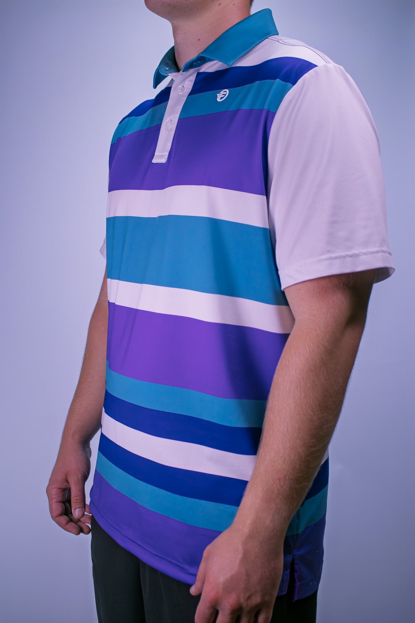 Person wearing a striped polo shirt with purple, blue, and white colors on a plain background
