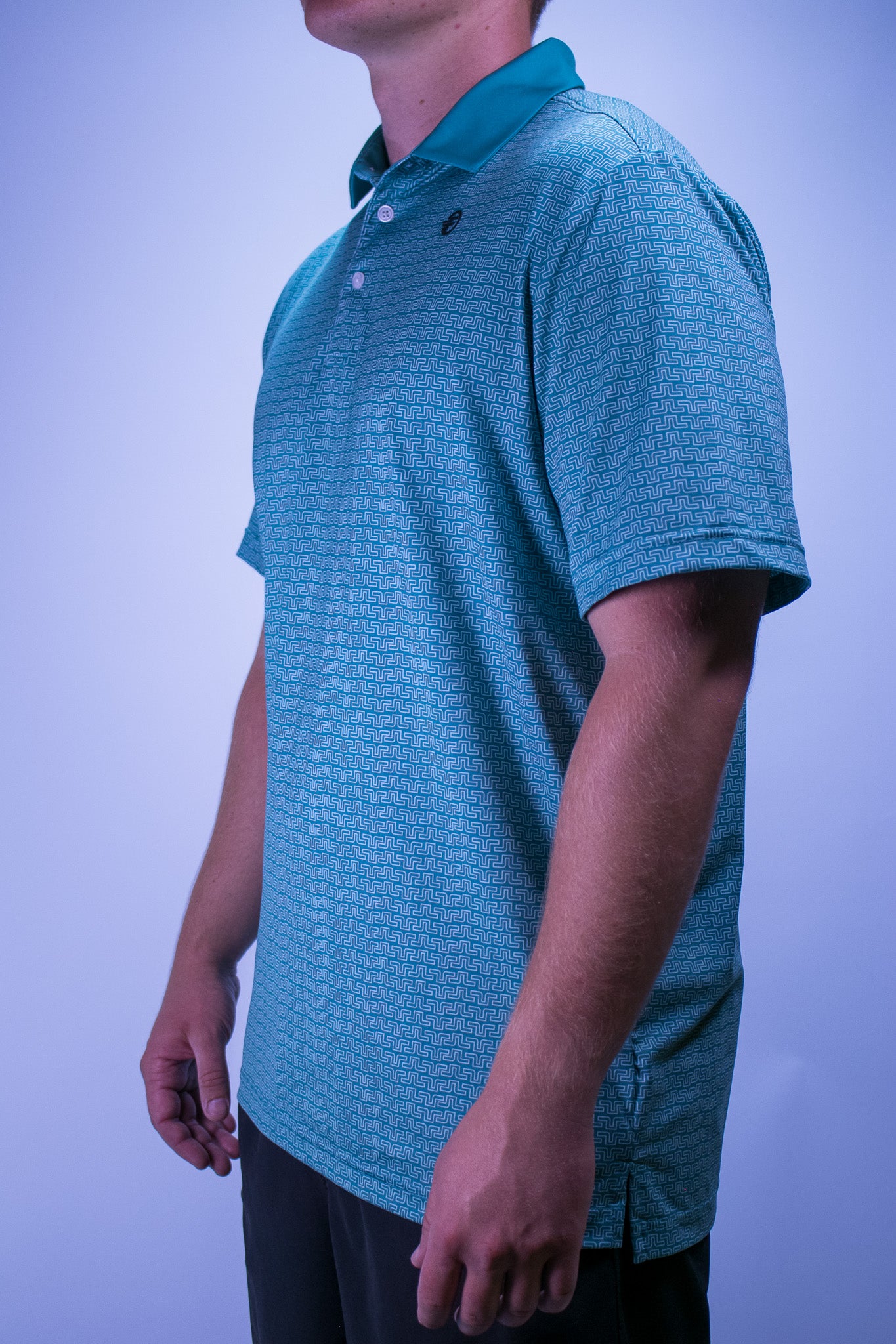 Person wearing a premium golf polo with a design on it