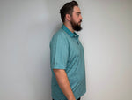 Man modeling a golf polo that is a blue base and white design