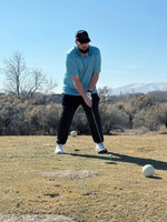 Golfer stepping up to a golf ball getting ready to  hit a ball