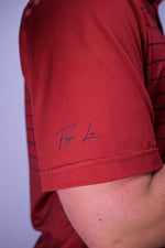 Red striped polo with cursive logo on sleeve