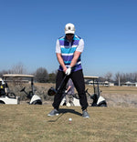 Man standing on tee box preparing to hit the golf ball 