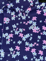 Navy blue fabric with pink and white floral pattern and logo in center