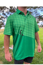 Person wearing a green checkered polo shirt with a graphic on a grassy background