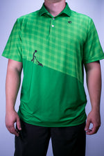 Green Checkered Polo with figure mowing lines into a lawn