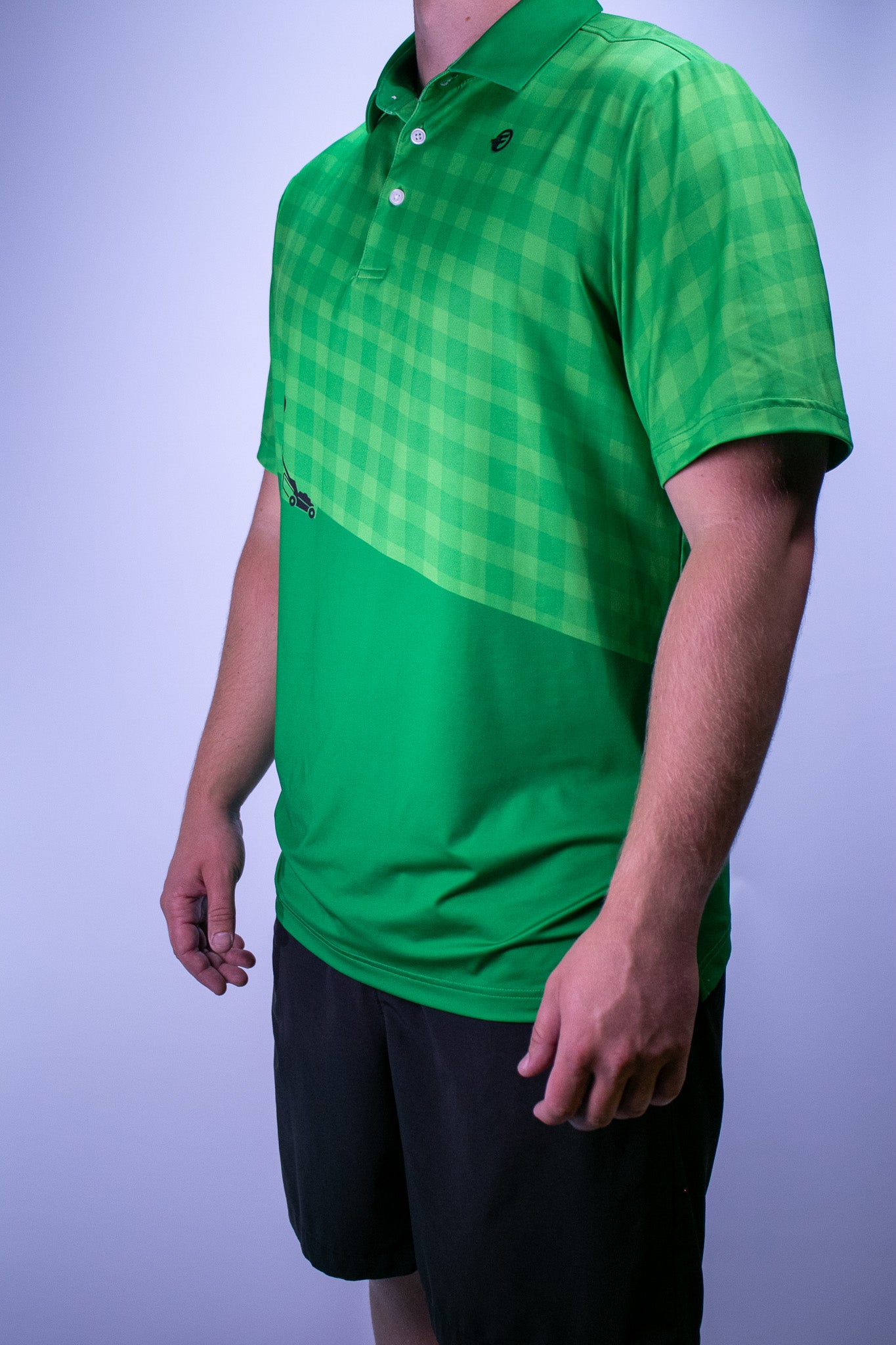 Green polo picturing a figure mowing lawn stripes
